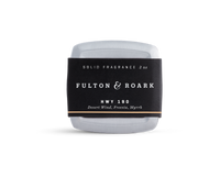 A rectangular metal tin of Fulton & Roark solid fragrance, HWY 190, with a black label featuring the scents Desert Wind, Freesia, and Myrrh. The tin is placed against a plain white background.