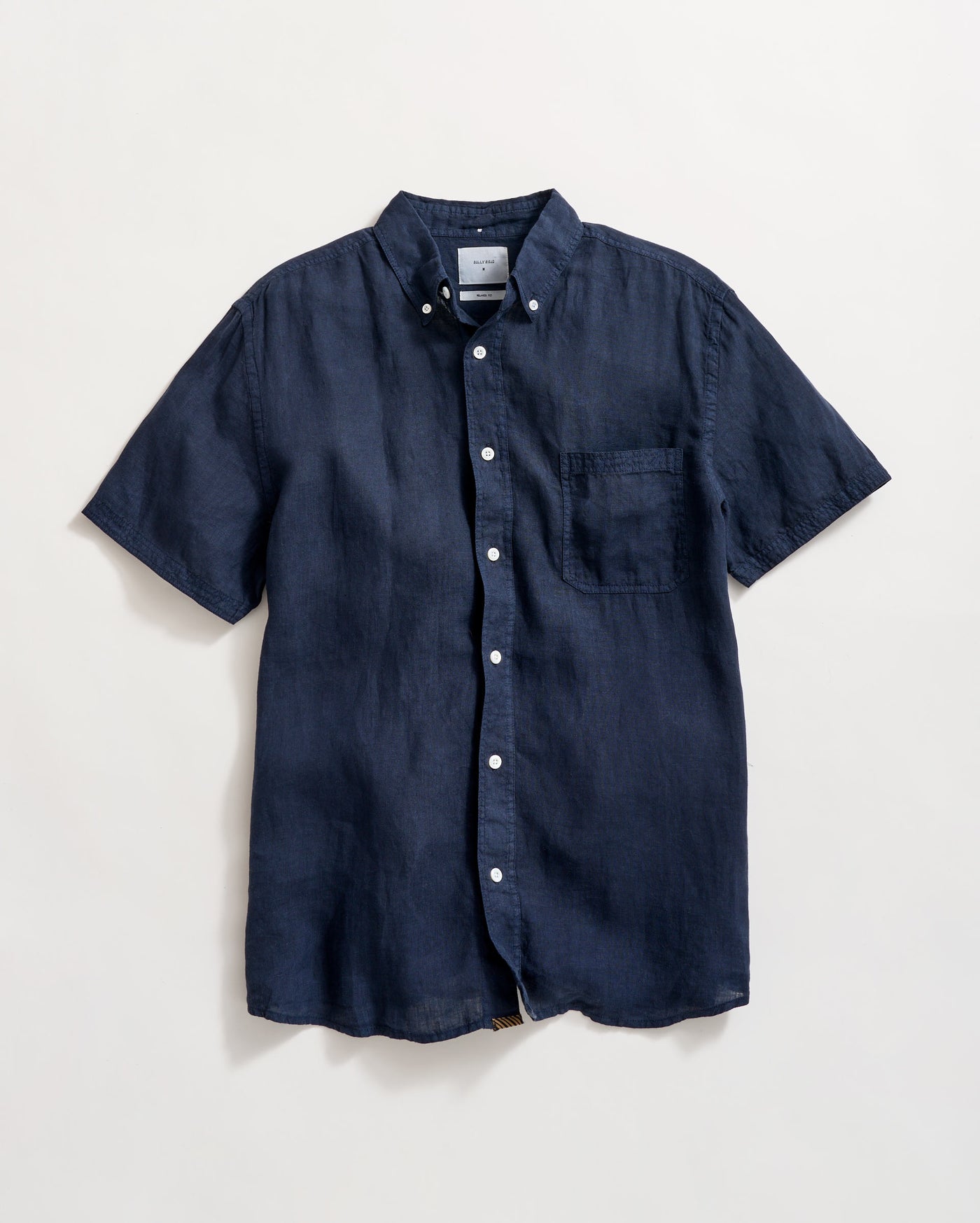 A navy blue short-sleeve button-up shirt with a button-down collar and a chest pocket, laid flat on a light background.