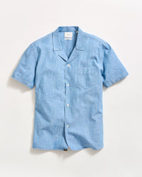 A light blue short-sleeve button-up shirt with a notched collar and a chest pocket, laid flat on a white background.
