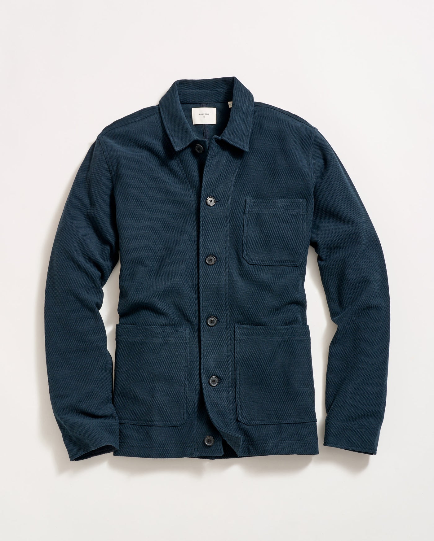 A navy blue button-up jacket with a collar, long sleeves, and three front pockets, laid flat on a white background.
