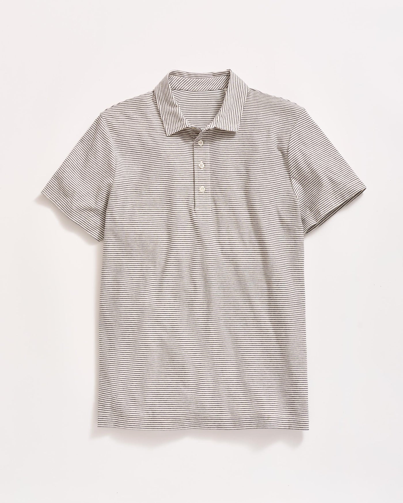 A short-sleeve, light gray polo shirt with thin, horizontal black stripes, a collar, and three buttons down the front, laid flat on a white background.