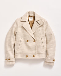 A cream-colored, double-breasted wool jacket with brown buttons, two front pockets, a notched collar, and buttoned cuffs, laid flat on a white background.
