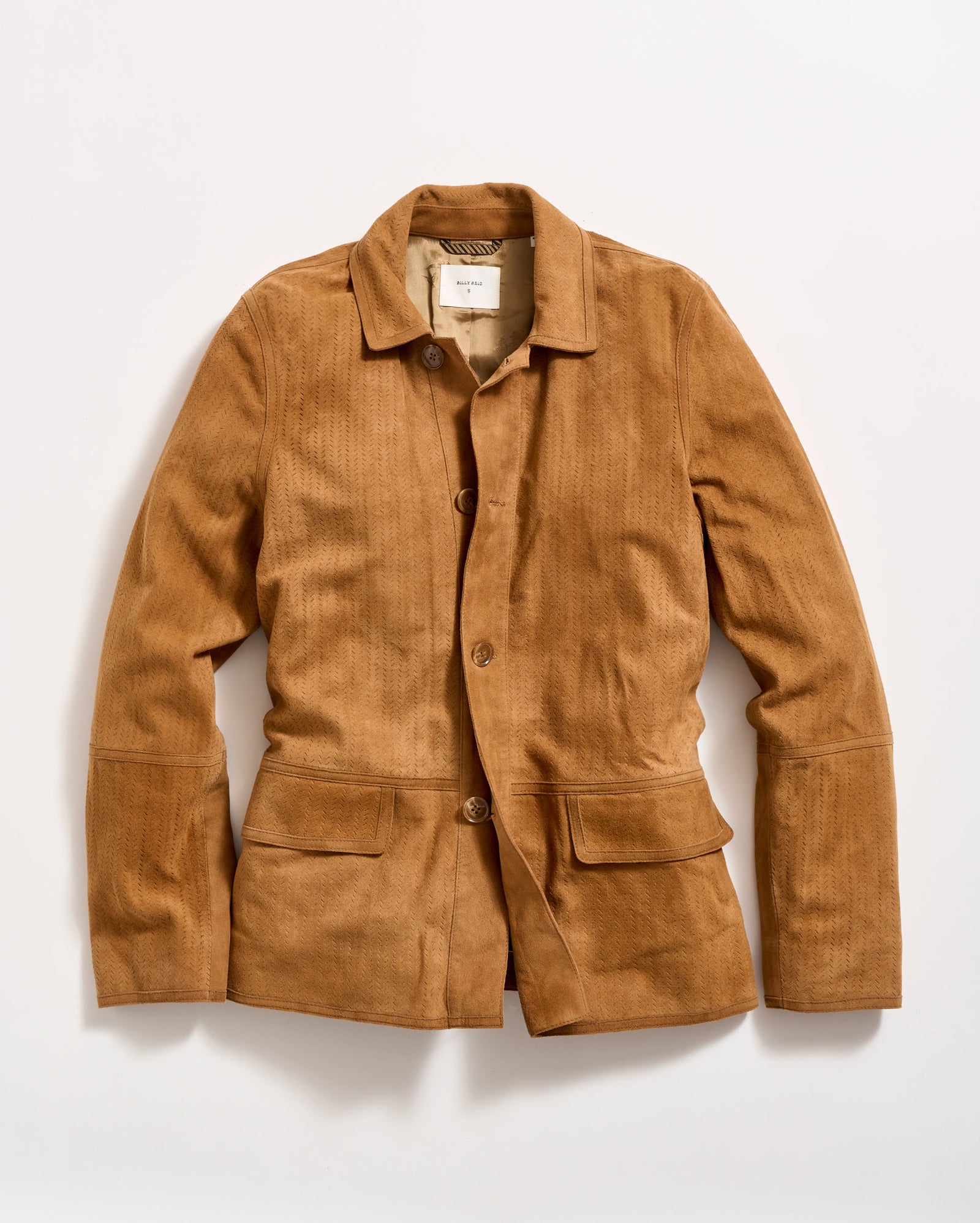 A light brown, long-sleeve jacket with a collar, button front, and two large front pockets, laid flat on a white background. The jacket has a tailored fit and a subtle textured pattern.