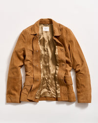 A light brown suede jacket with a shiny beige satin lining is laid flat on a white background. The jacket is unbuttoned, showing the inside and the front pockets.