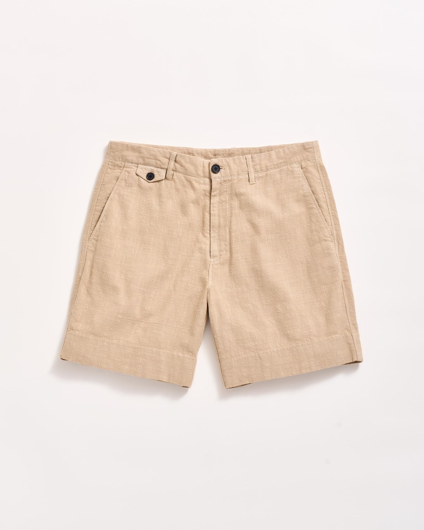 A pair of beige linen shorts with side pockets, belt loops, and a front button and zipper closure, displayed flat on a white background.