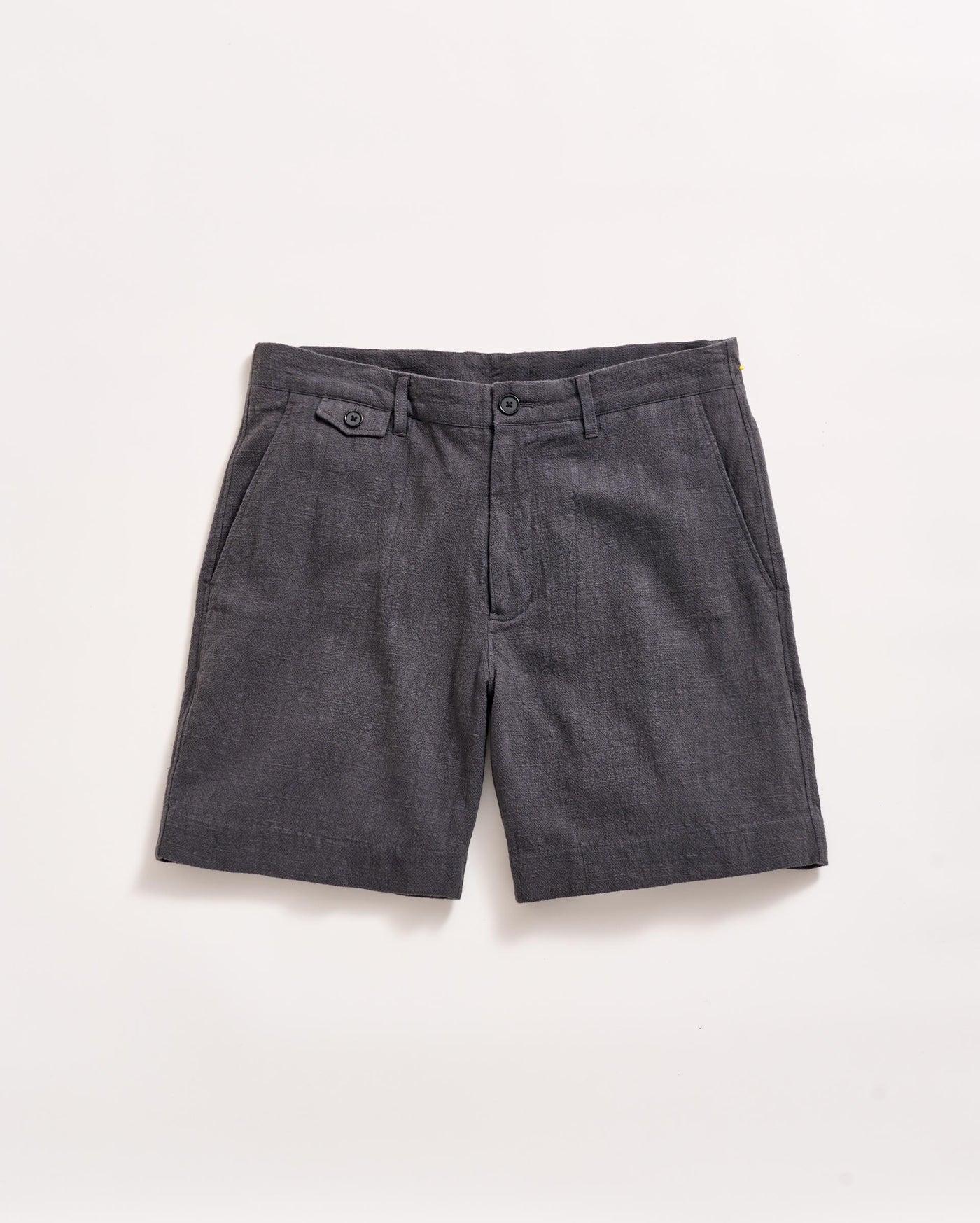 Dark gray tailored shorts with front pockets, belt loops, and button details, laid flat on a white background.