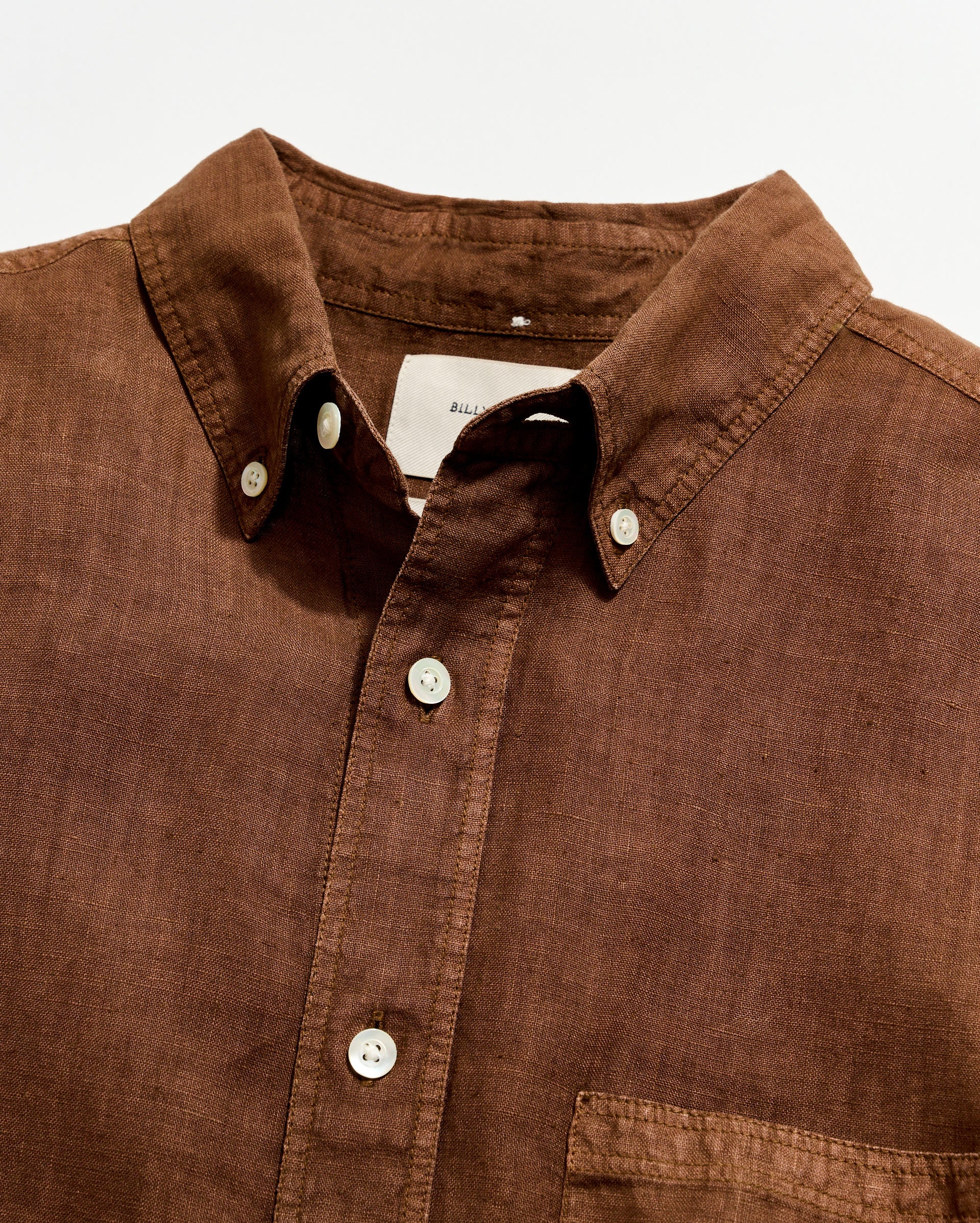 Brown shirt with collar and buttons on a white background