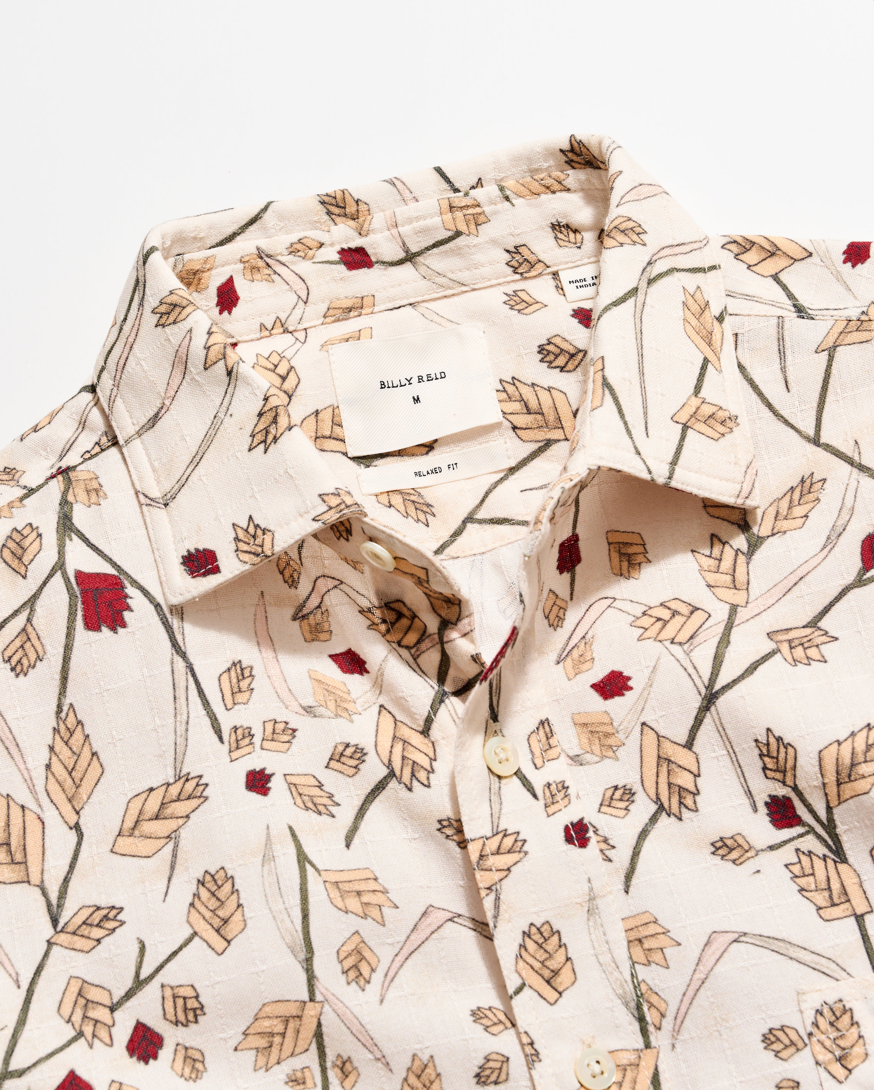 Floral patterned shirt with a visible brand label on a white background