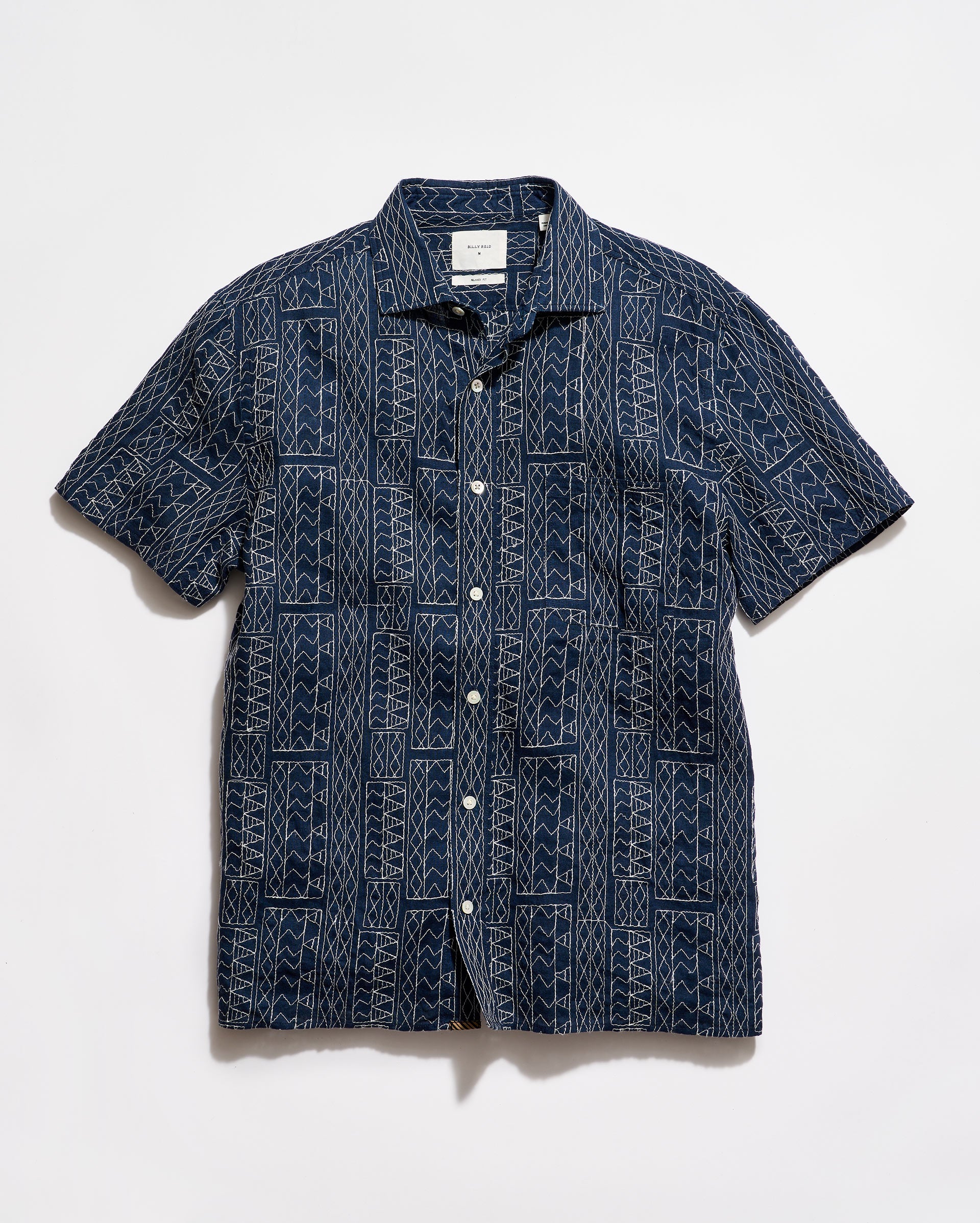Navy patterned shirt on a white background