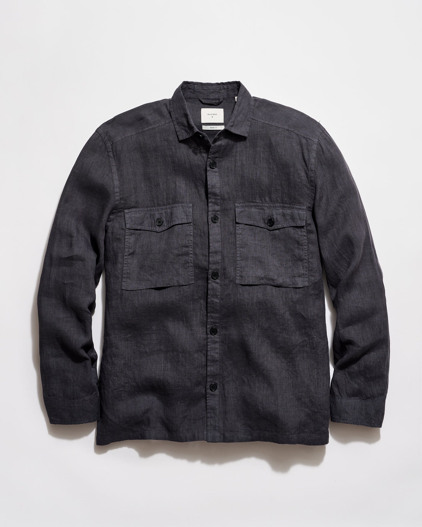Dark denim shirt with two front pockets on a light gray background