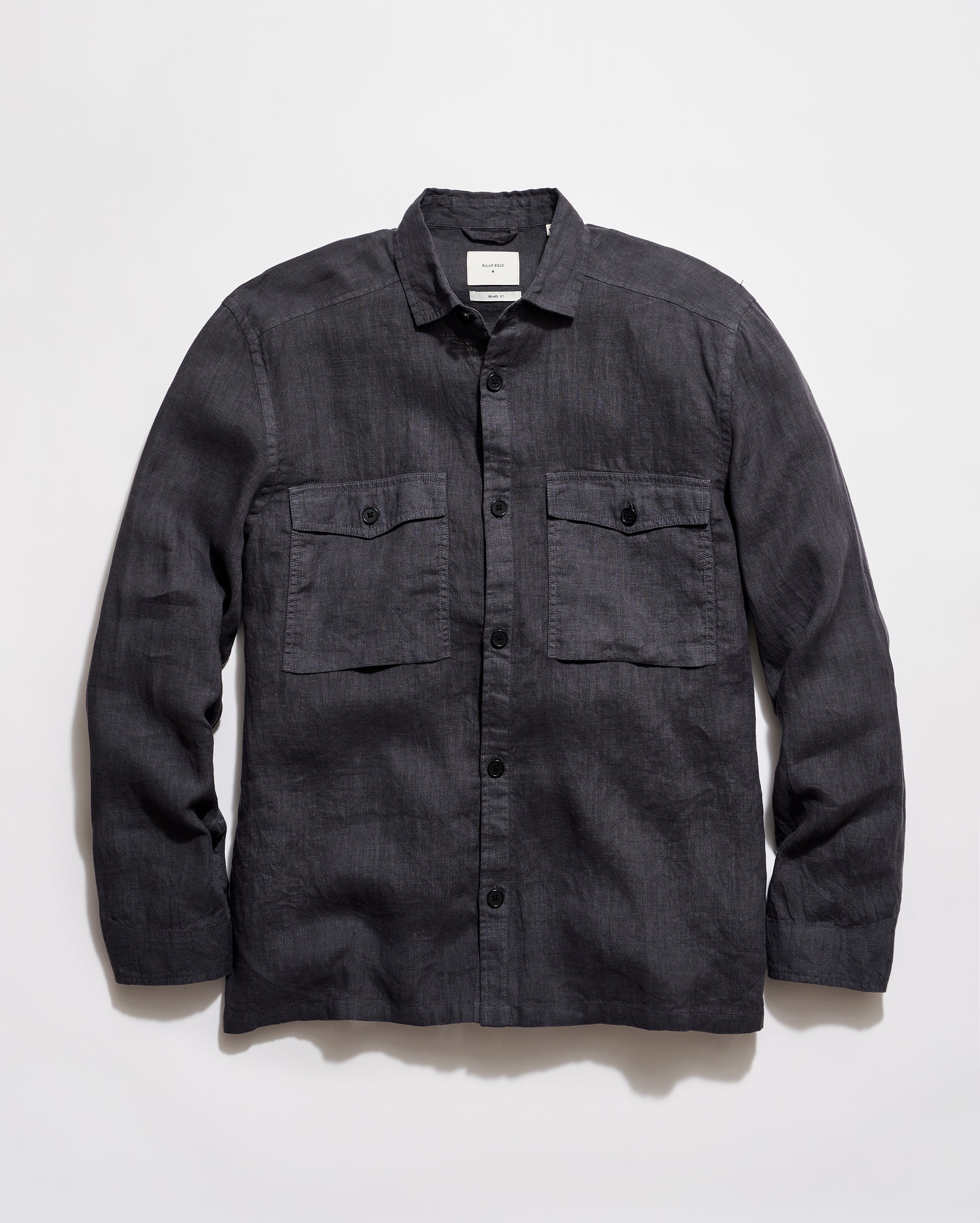 Dark denim shirt with two front pockets on a light gray background