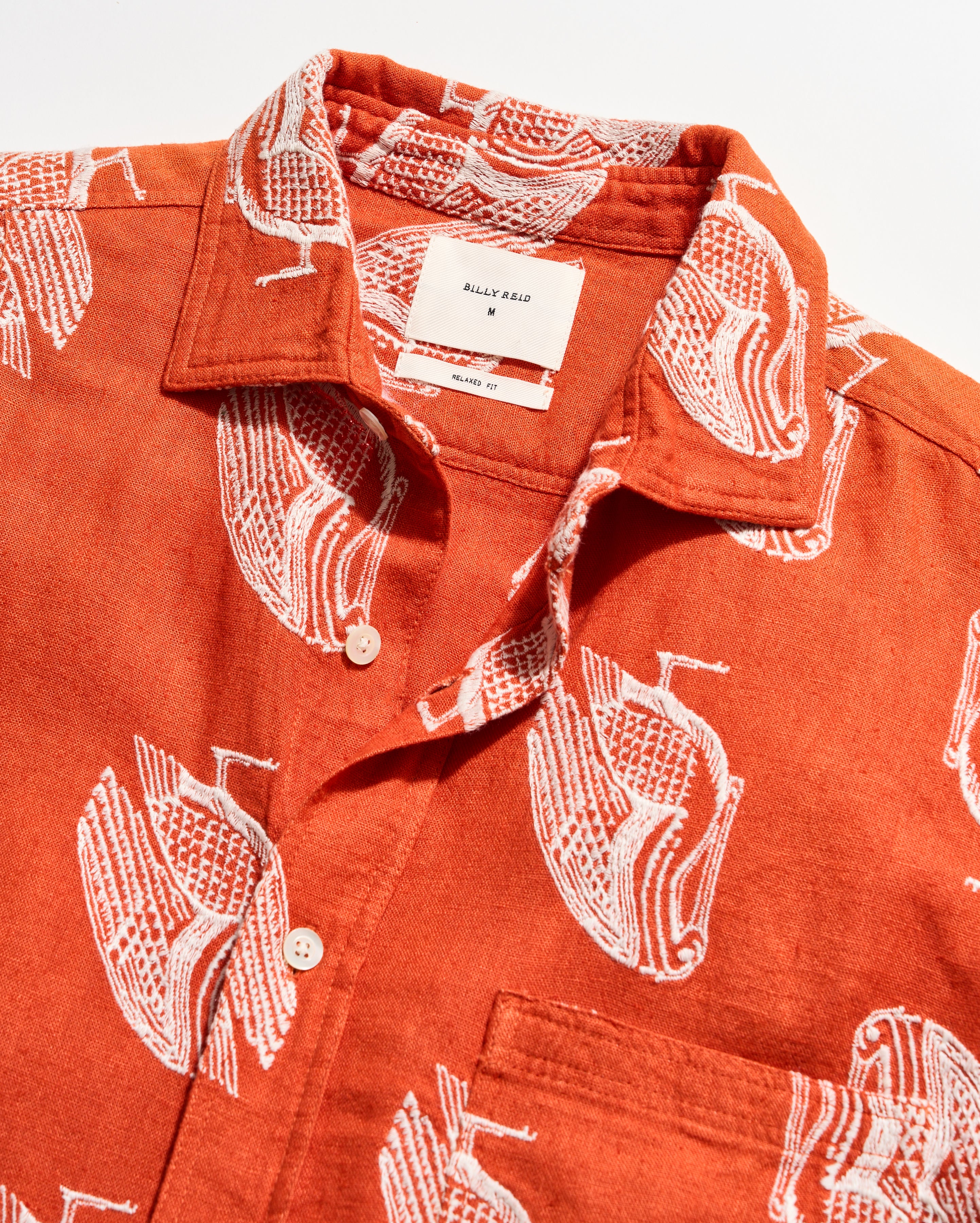 Red shirt with white graphic patterns on a white background