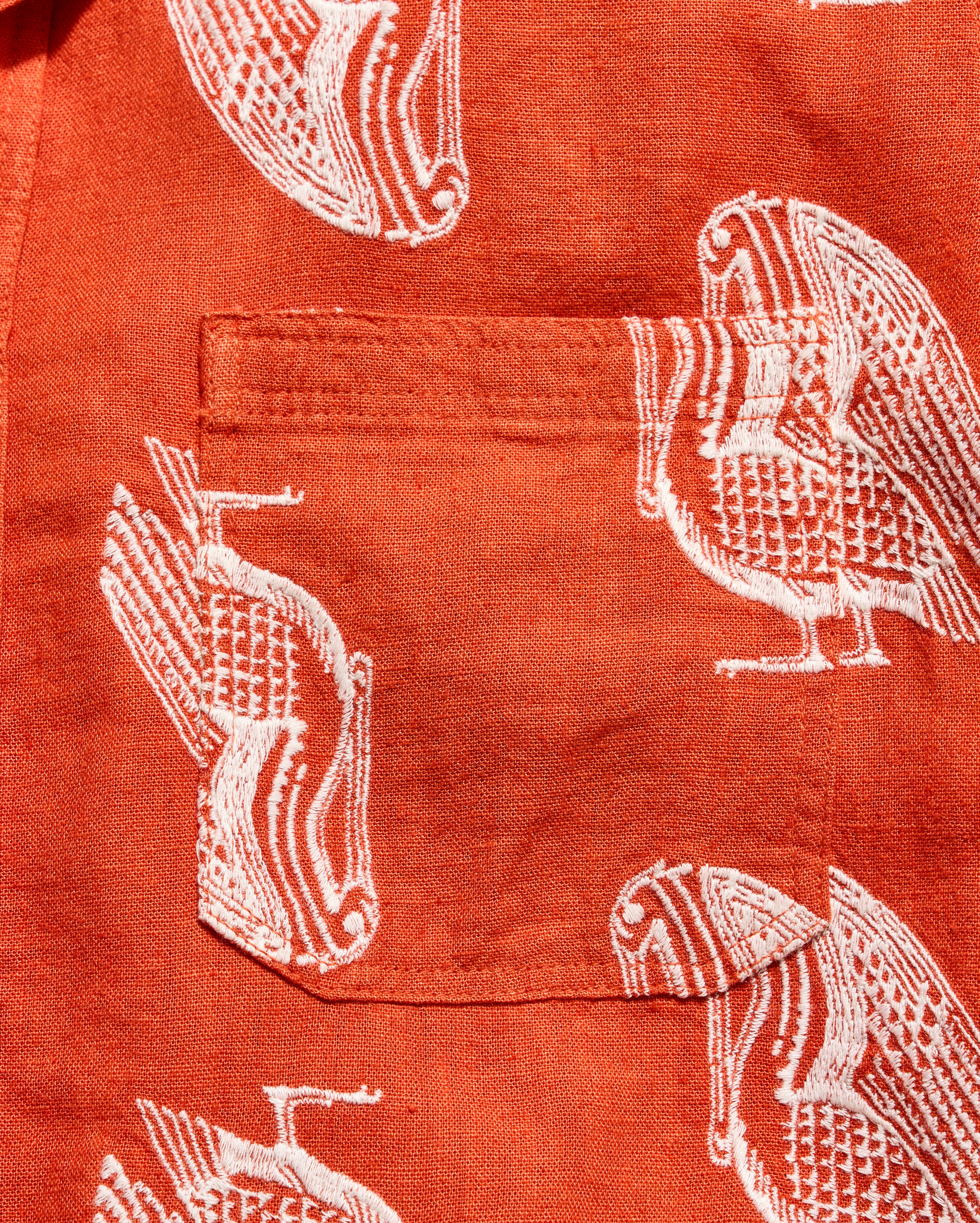 Red shirt with white bird pattern
