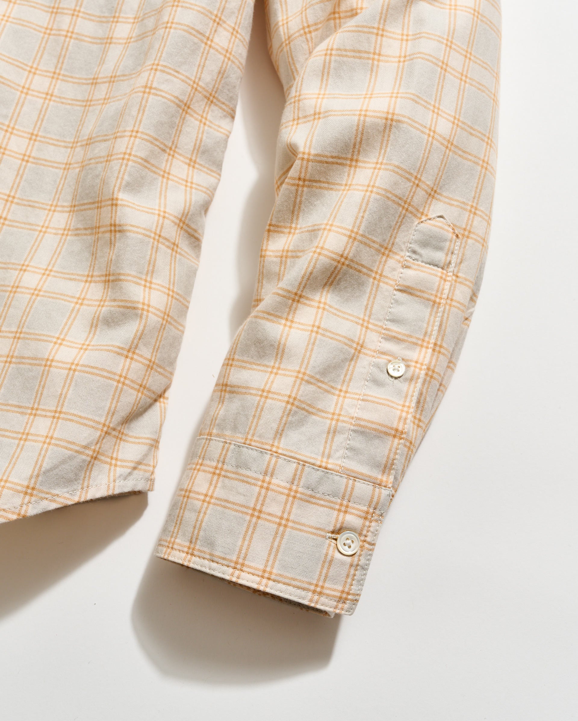 Plaid shirt with orange and gray pattern on a white background