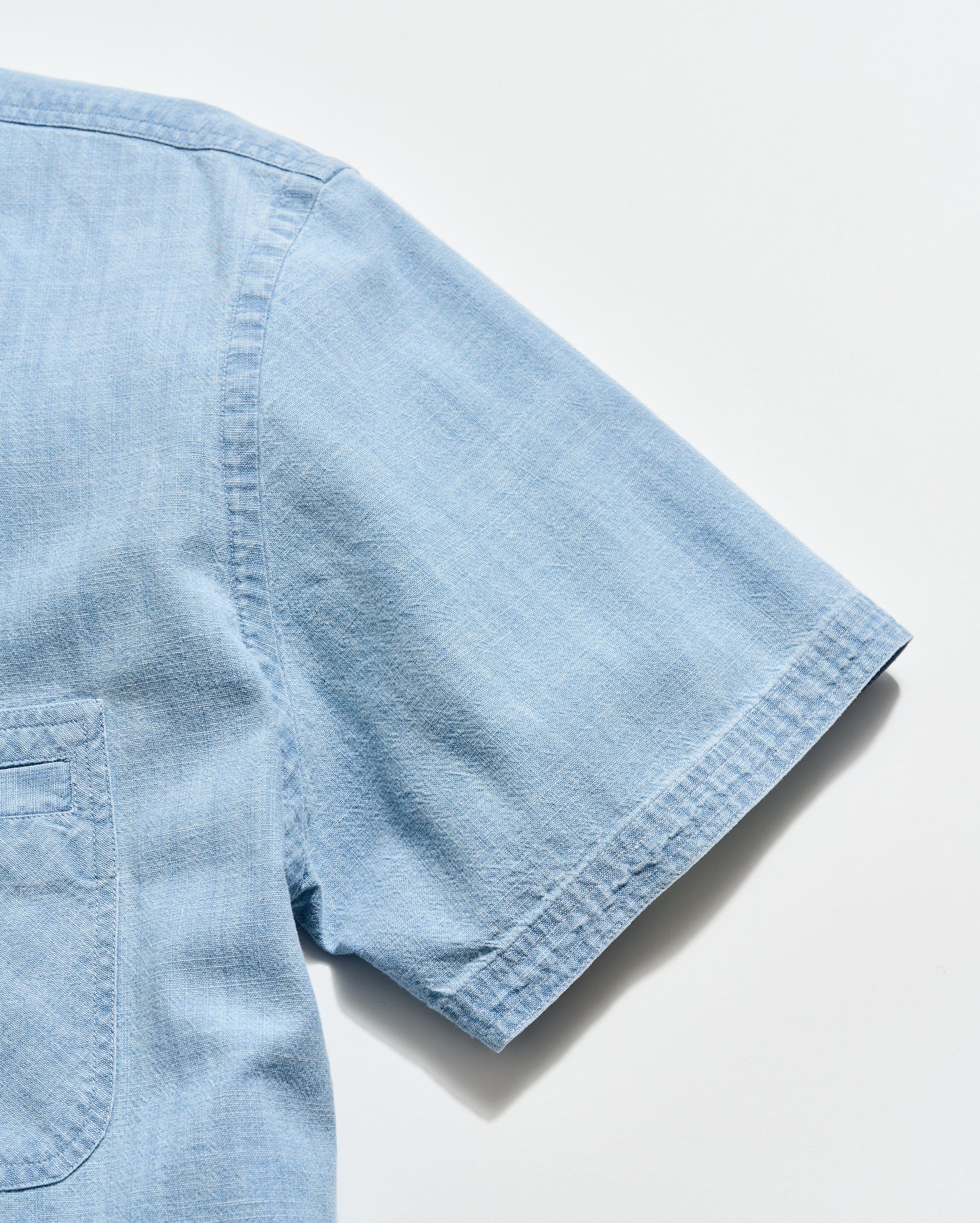 Light blue denim shirt on a white background