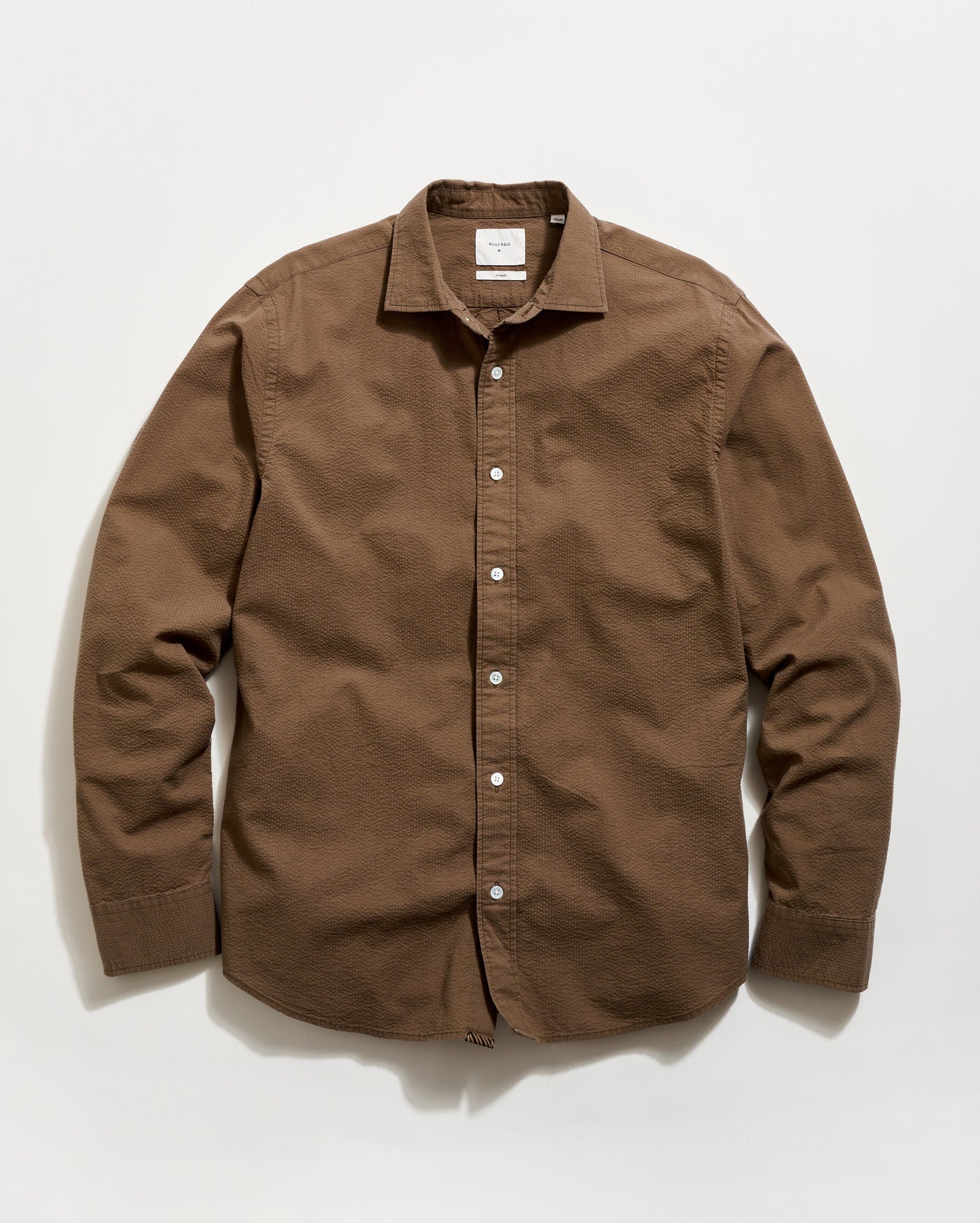 Brown button-up shirt on a white background