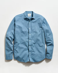 Blue button-up shirt on a light gray background