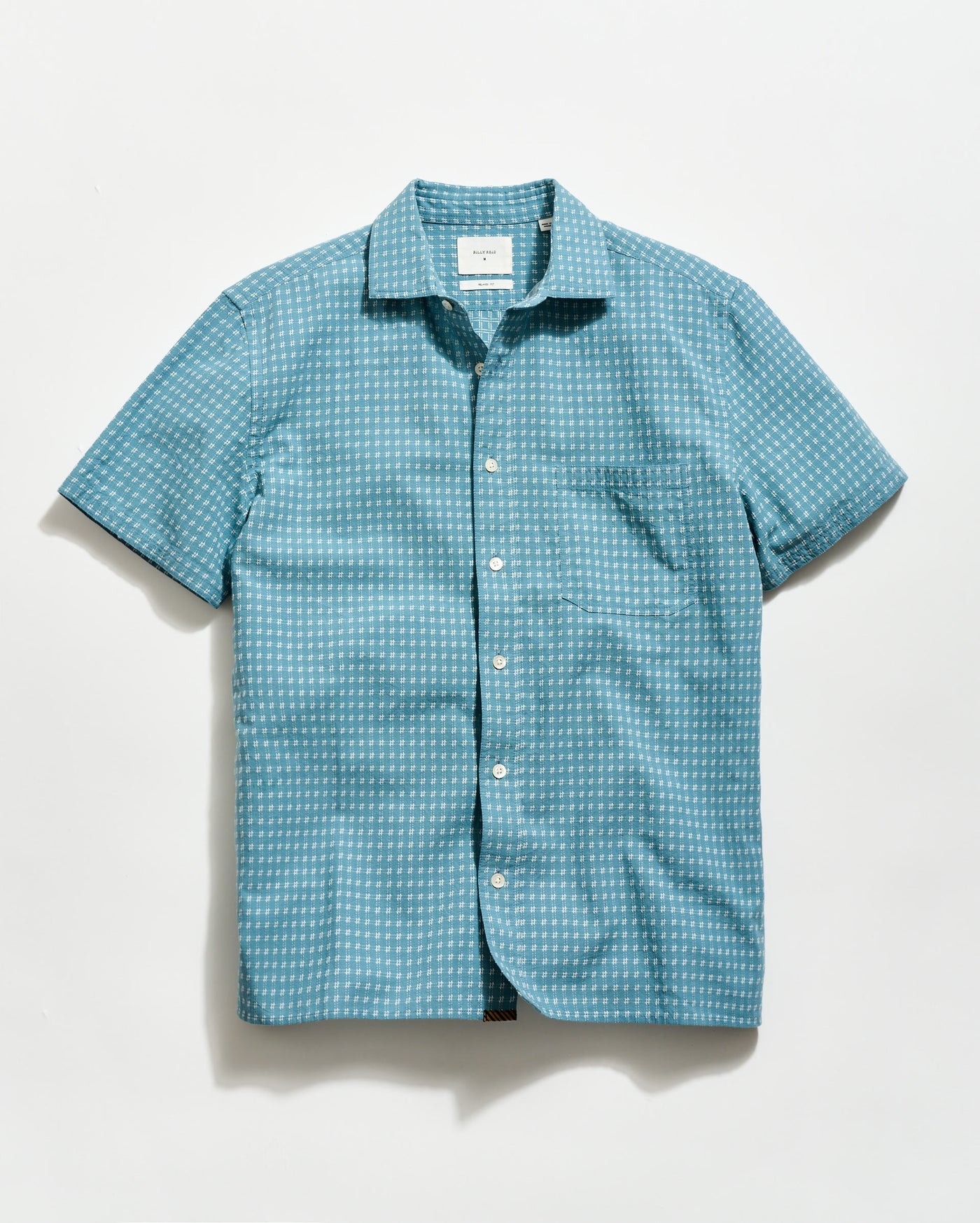 Blue patterned short-sleeve shirt on a light gray background