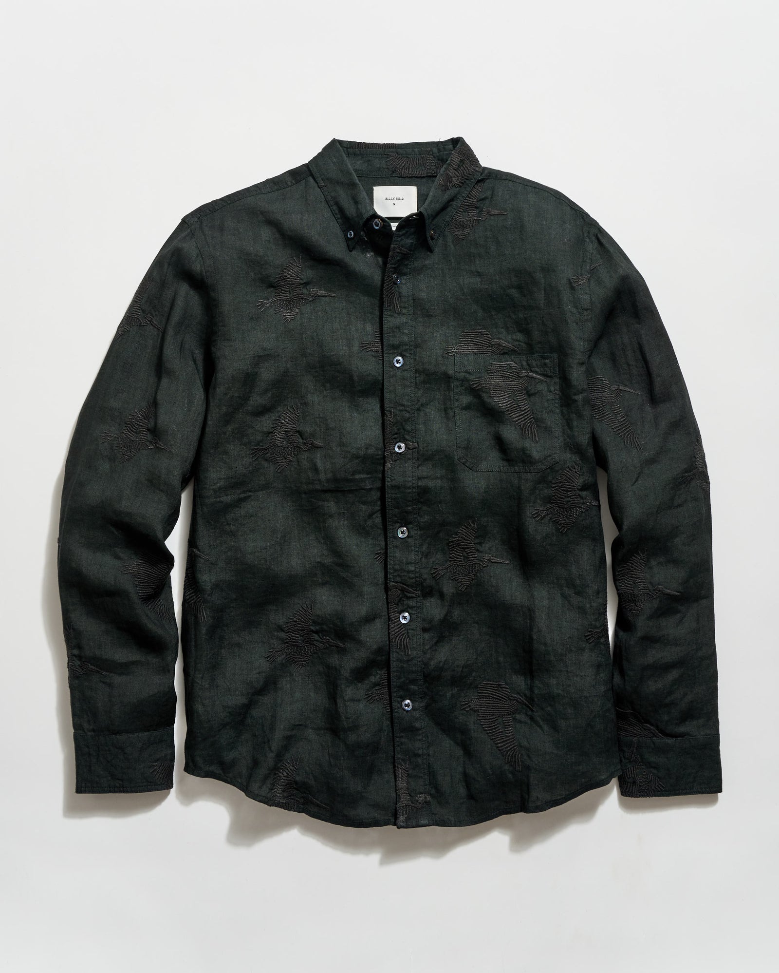 Black button-up shirt on a light gray background