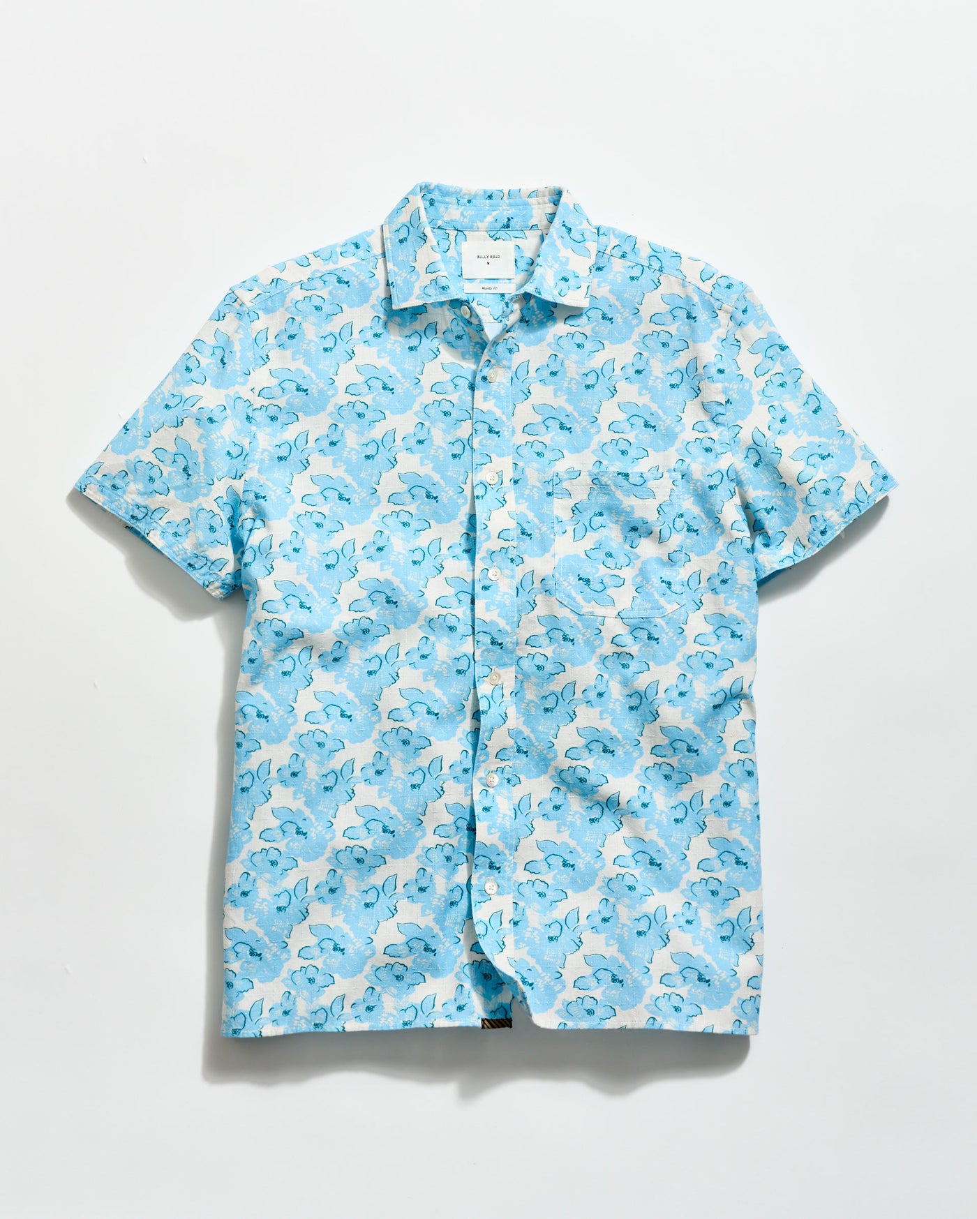 Blue and white patterned shirt on a light gray background