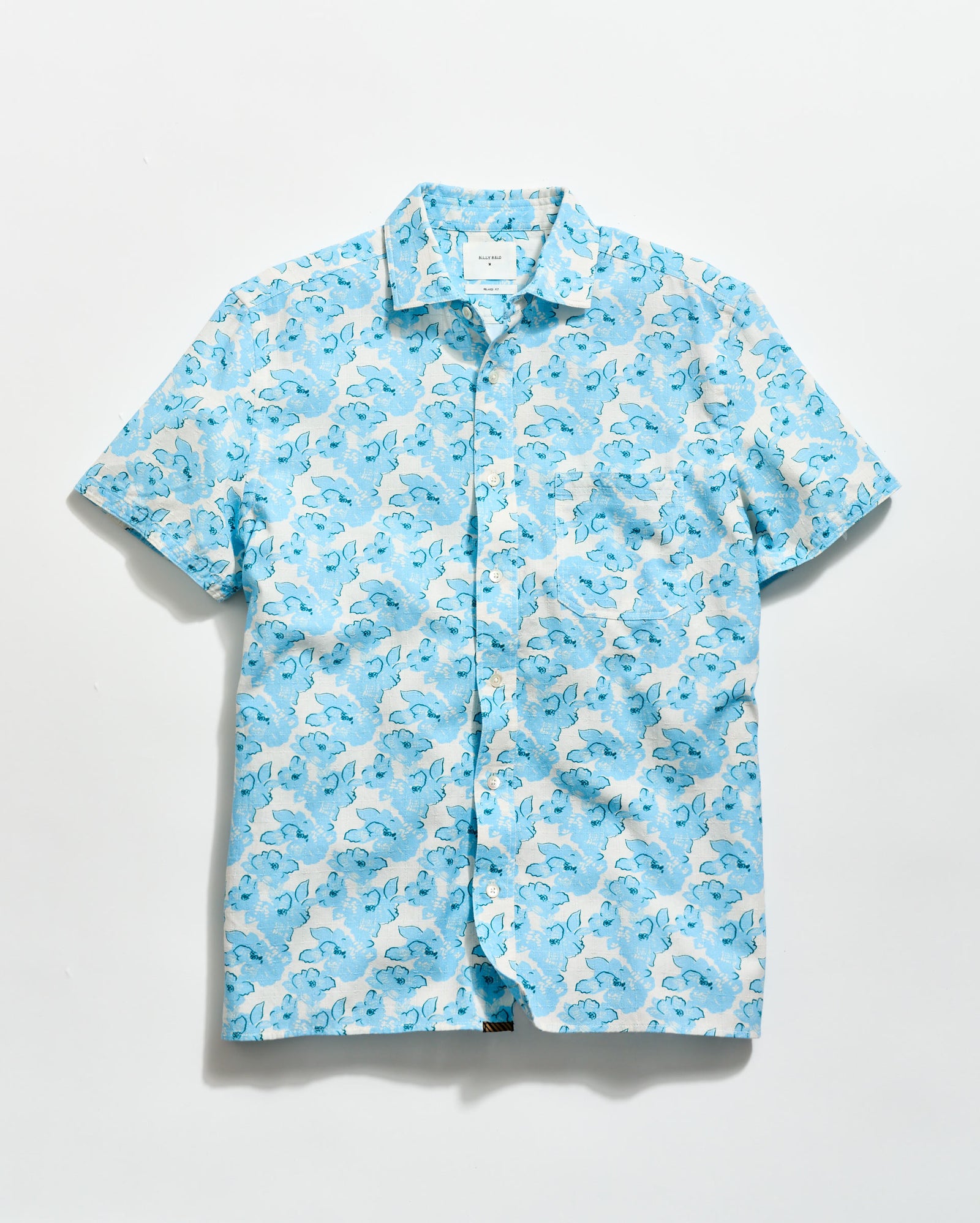 Blue and white patterned shirt on a light gray background