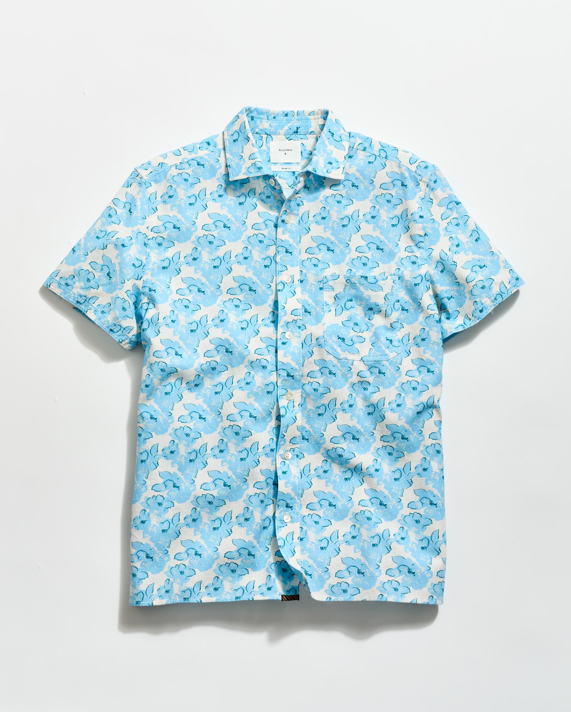 Blue and white patterned shirt on a light gray background