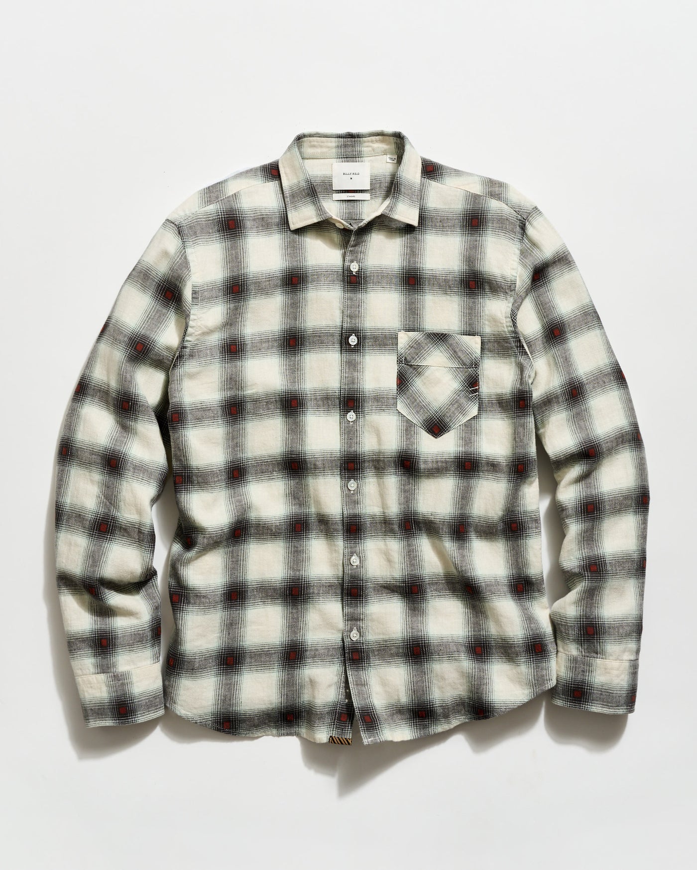 Plaid shirt with a pattern of black, red, and white on a light gray background