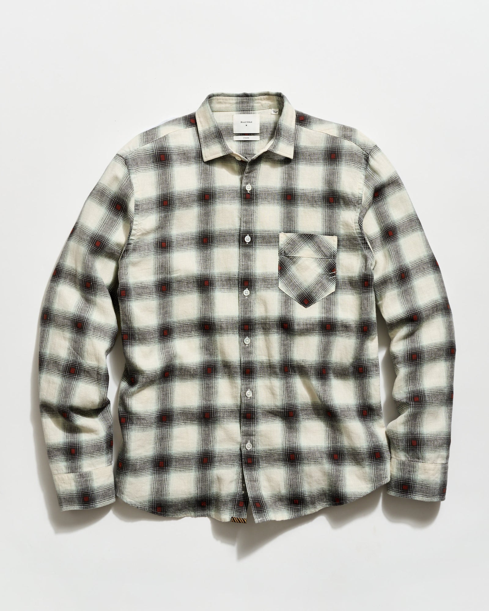 Plaid shirt with a pattern of black, red, and white on a light gray background