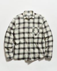 Plaid shirt with a pattern of black, red, and white on a light gray background