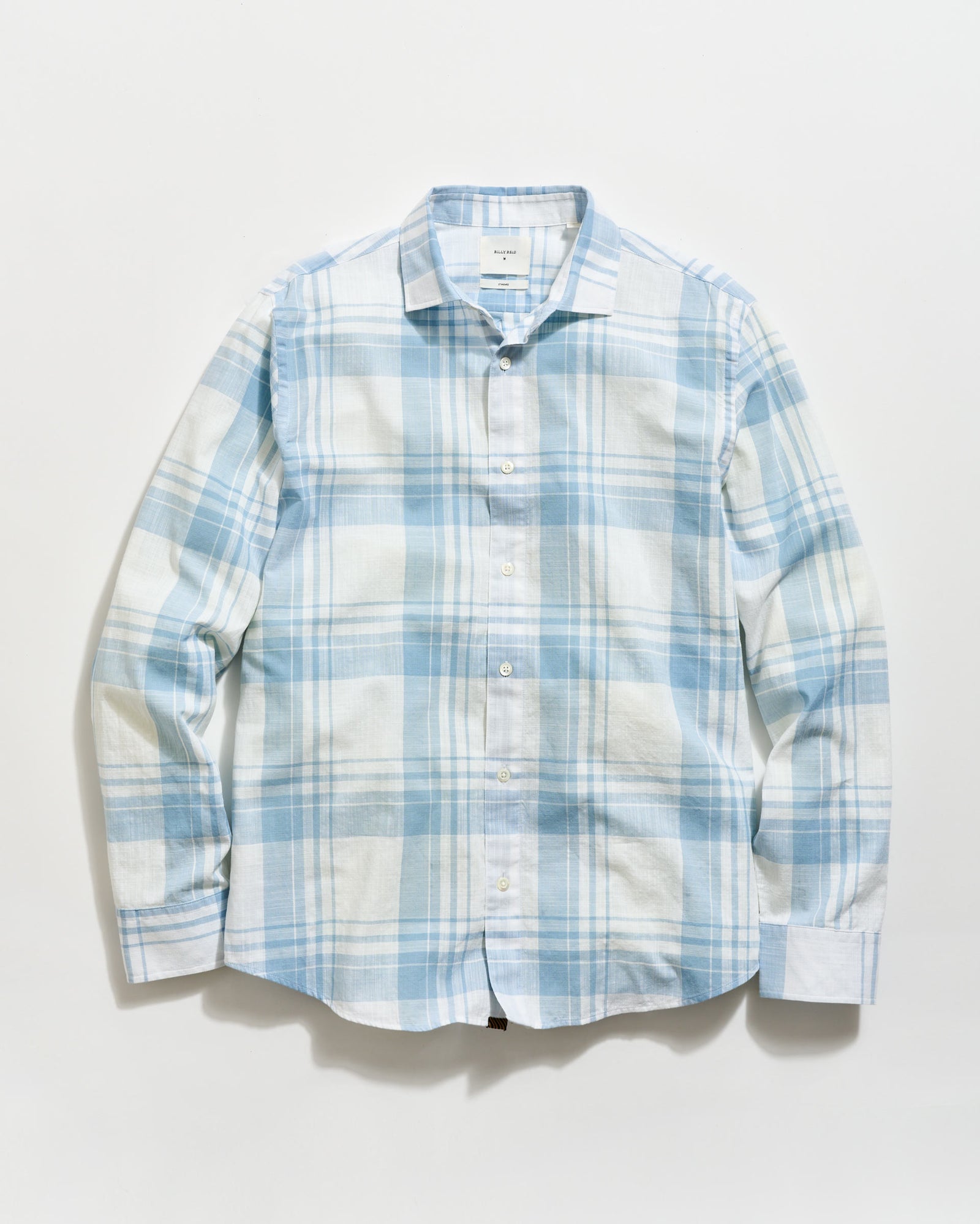 Blue and white plaid shirt on a light gray background