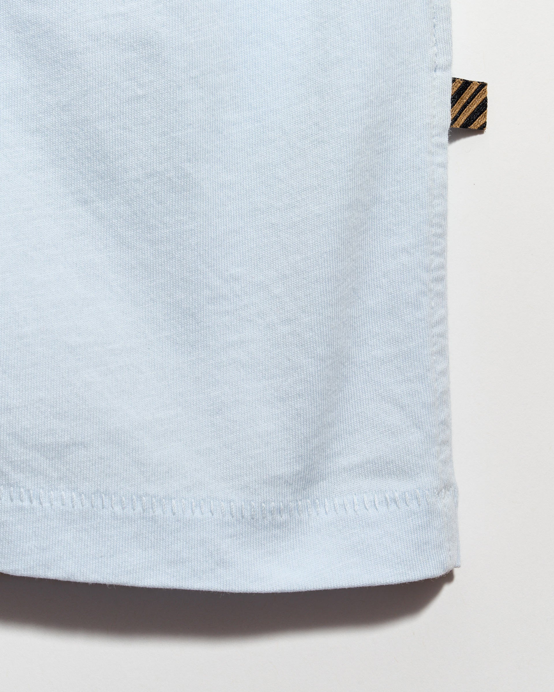 Light blue fabric with a brand label on a white background