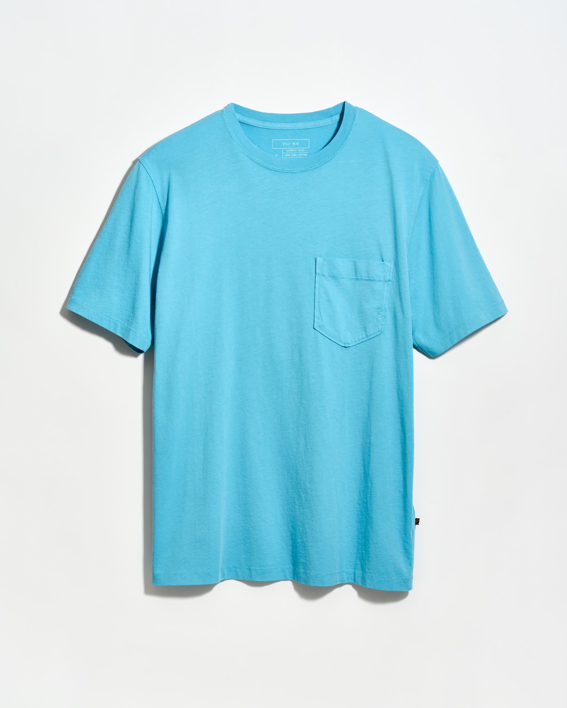 Blue t-shirt with a pocket on a light gray background