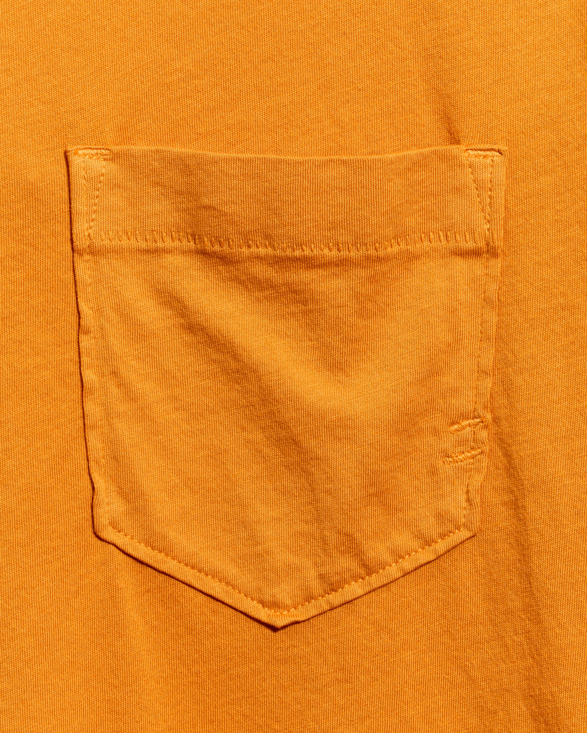 Close-up of an orange pocket on a matching orange shirt