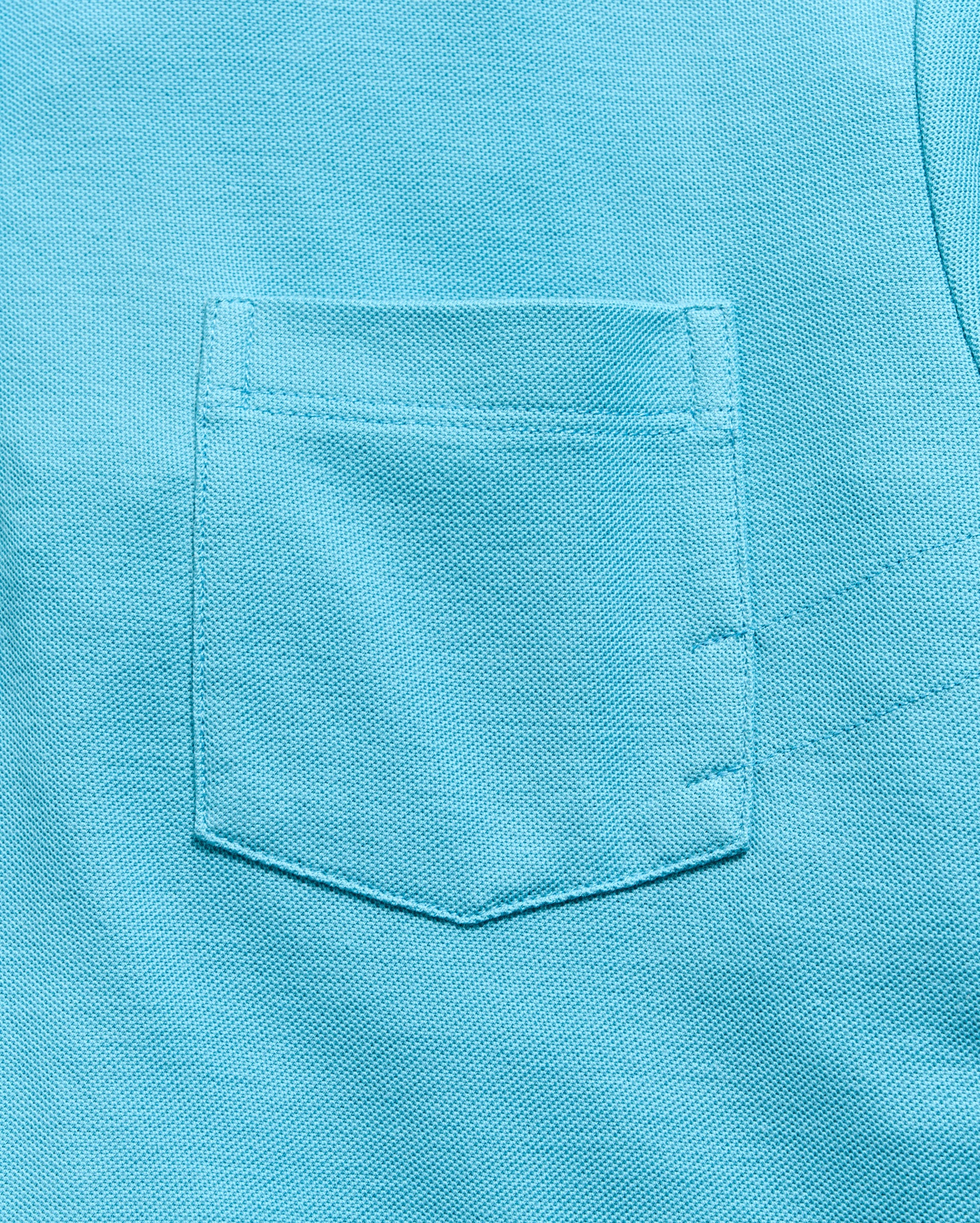 Close-up of a turquoise pocket on a shirt