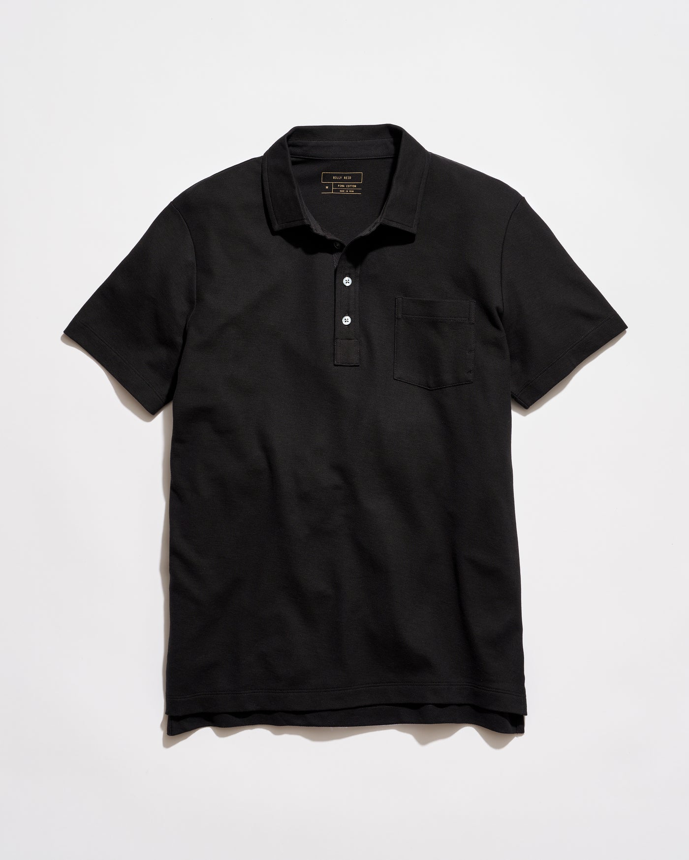 Black polo shirt on a light gray background