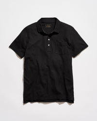 Black polo shirt on a light gray background