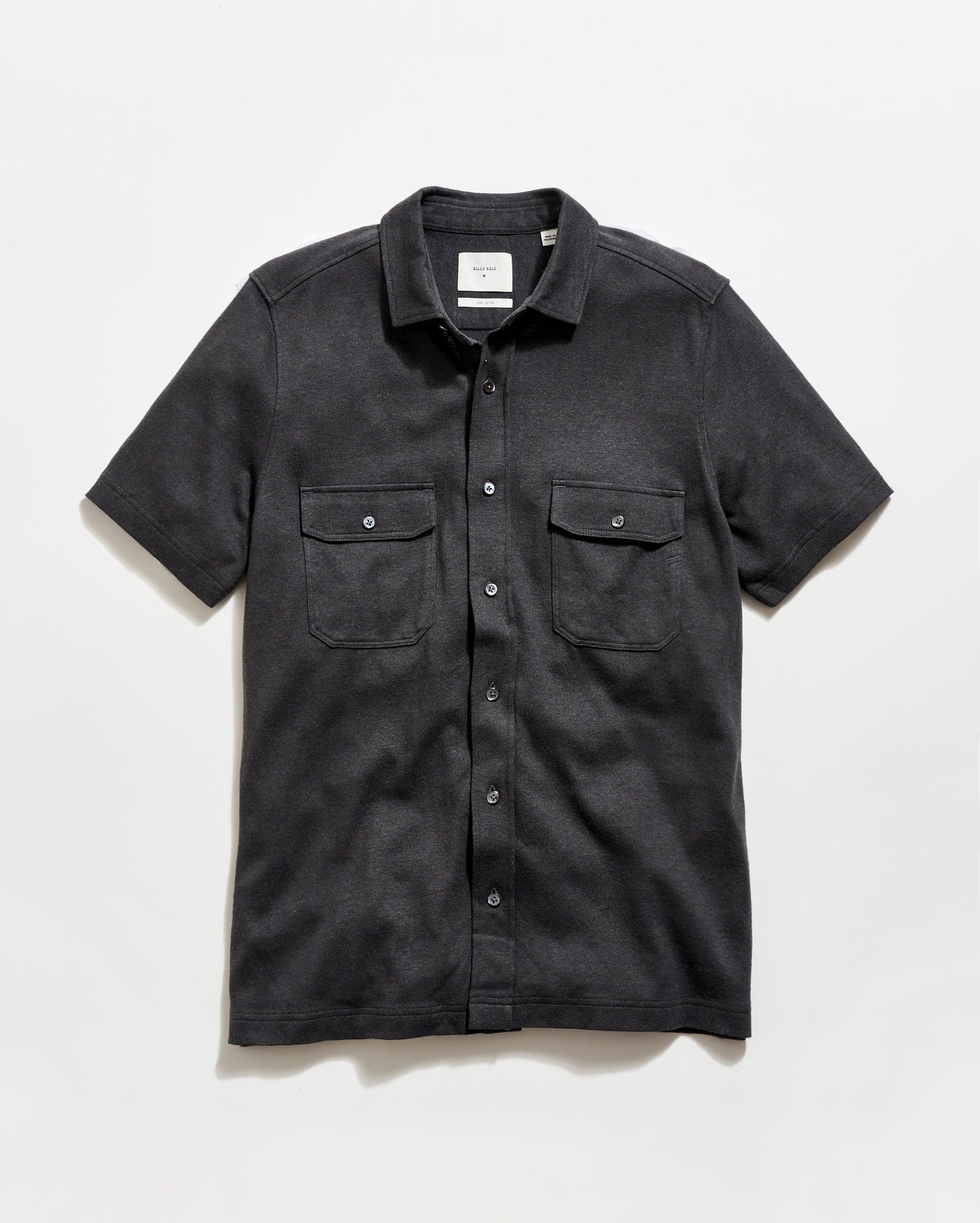 Black short-sleeve shirt with two pockets on a white background