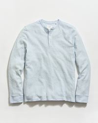 Light blue long-sleeve shirt on a light gray background