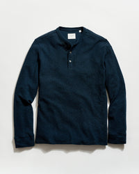 Navy long-sleeve henley shirt on a light gray background