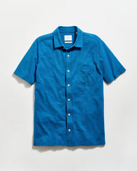 Blue short-sleeve shirt with a collar on a light gray background