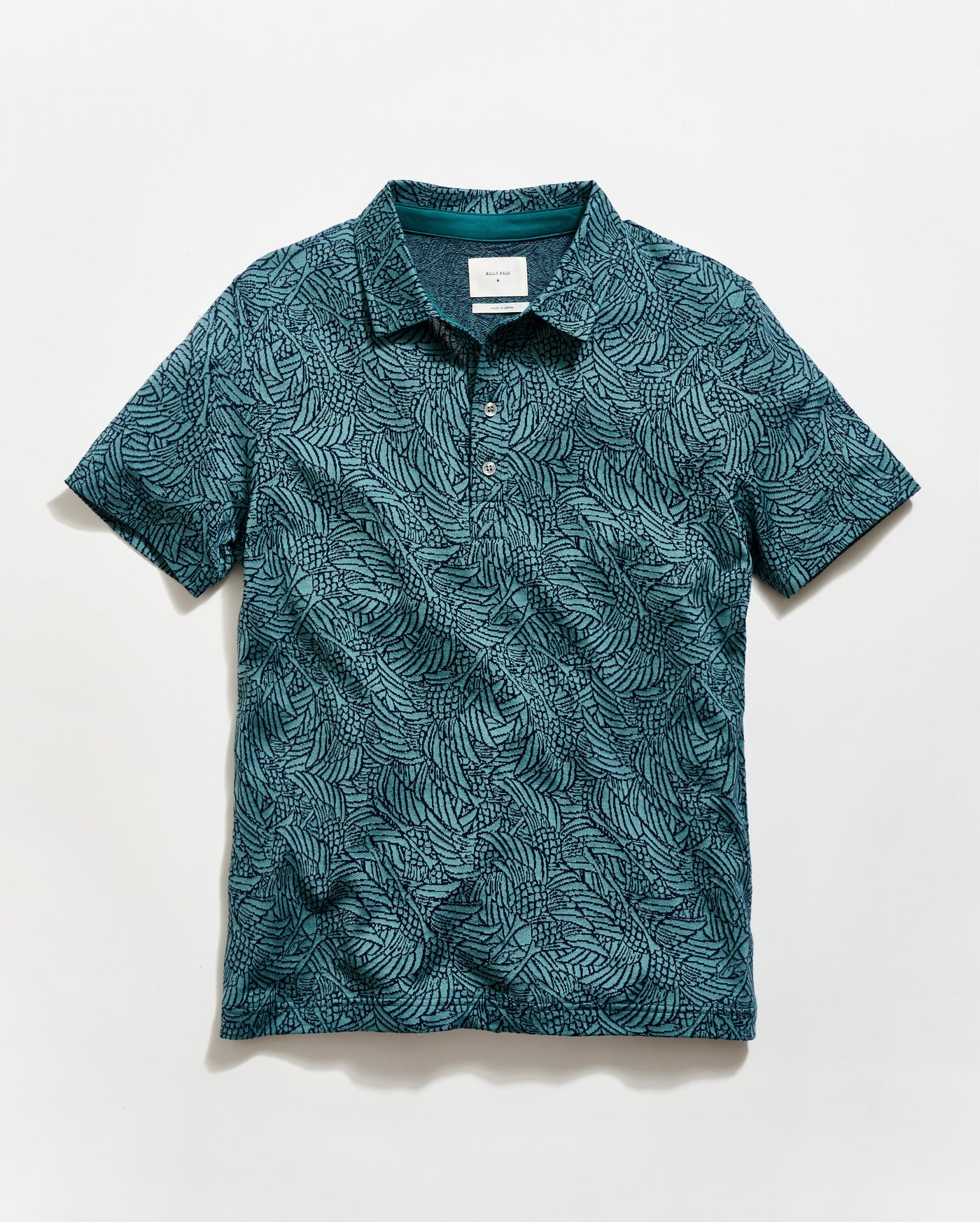 Green patterned polo shirt on a white background