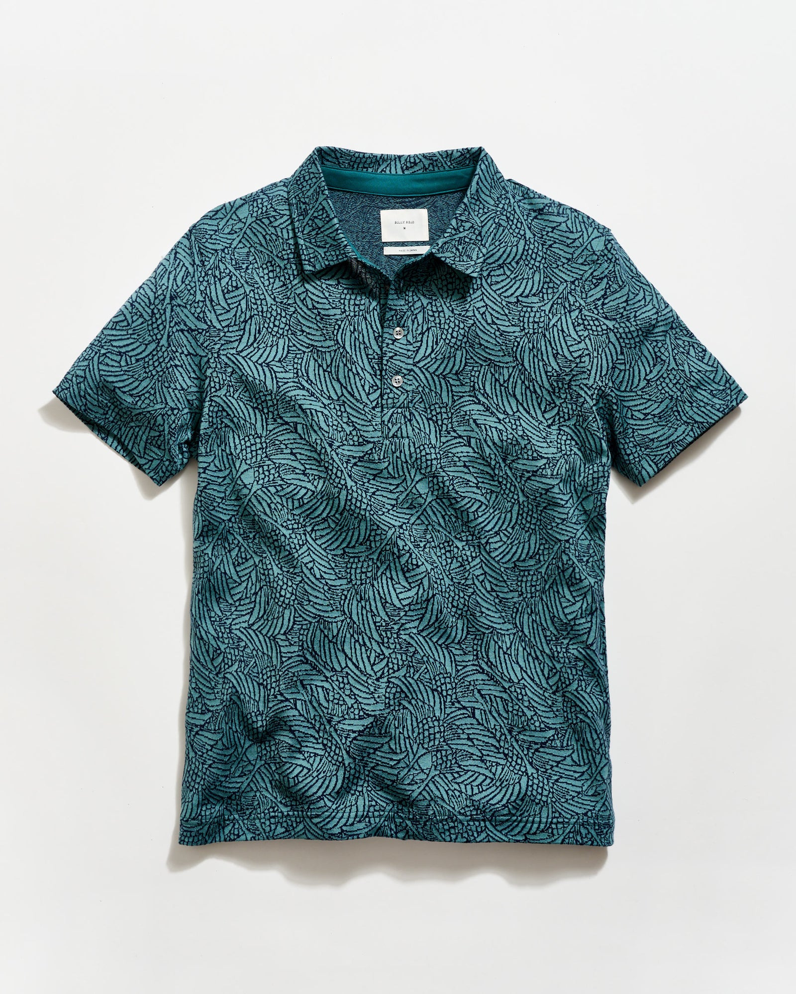 Green patterned polo shirt on a white background