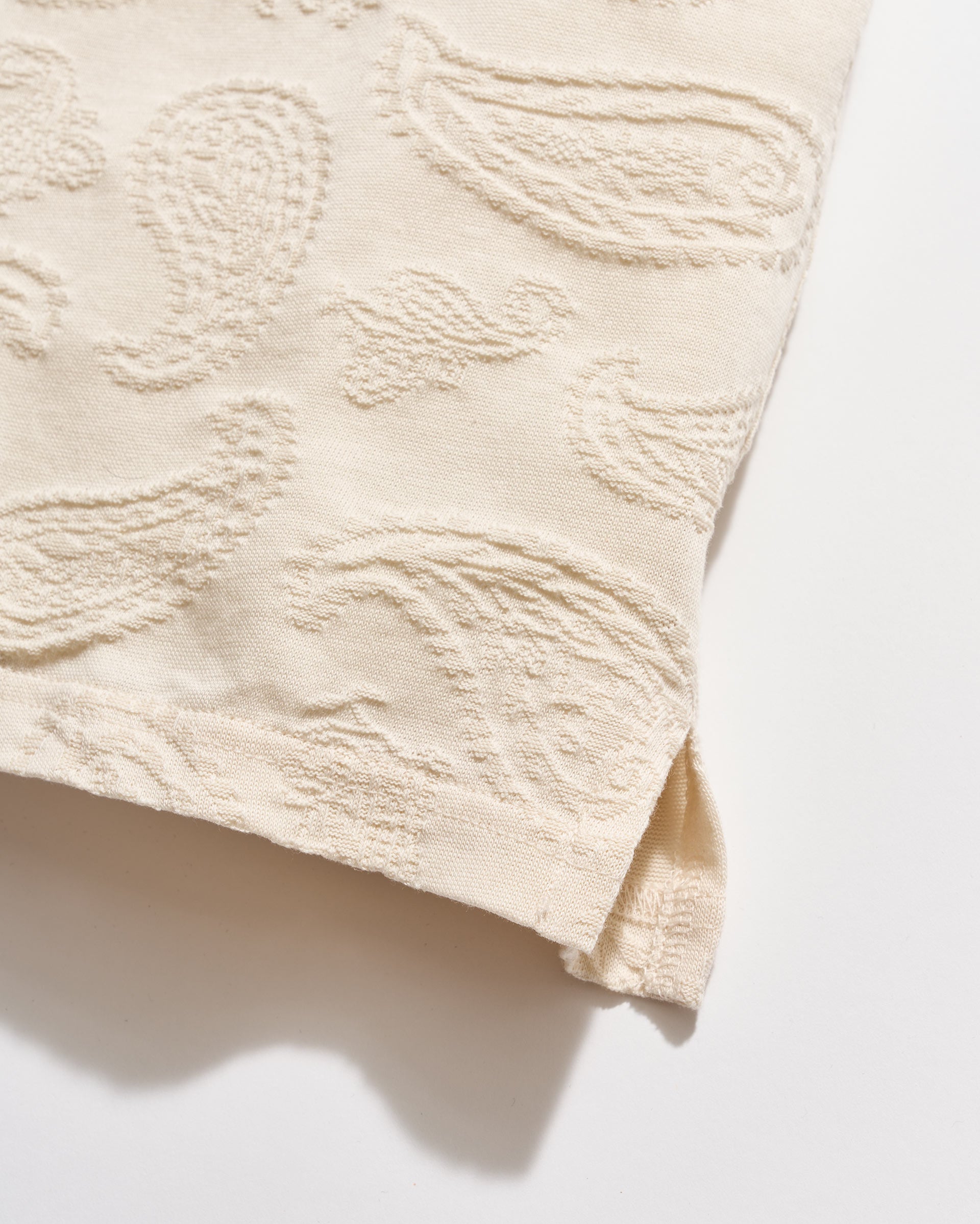 Textured beige fabric on a white background