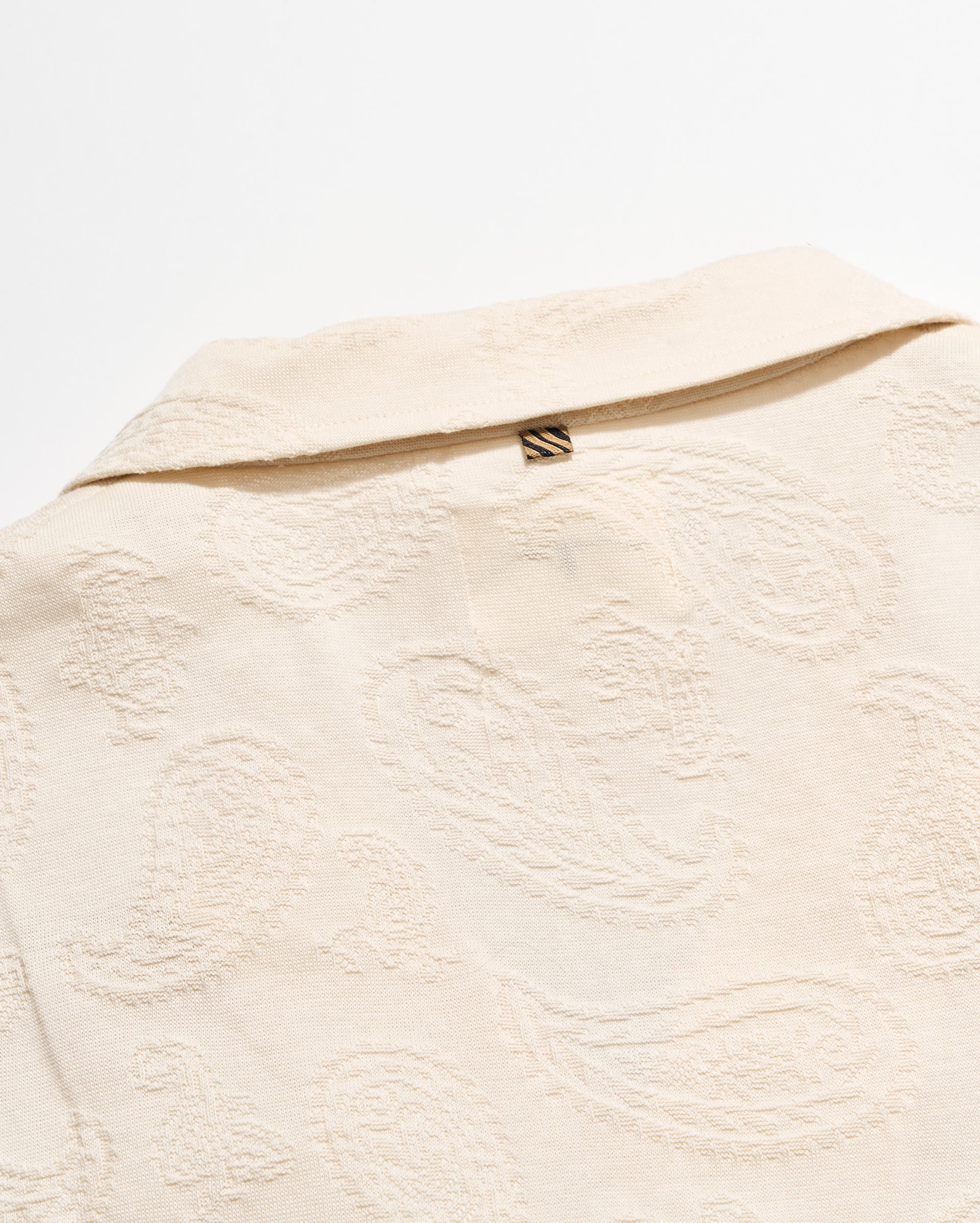Close-up of a textured beige fabric with a zipper