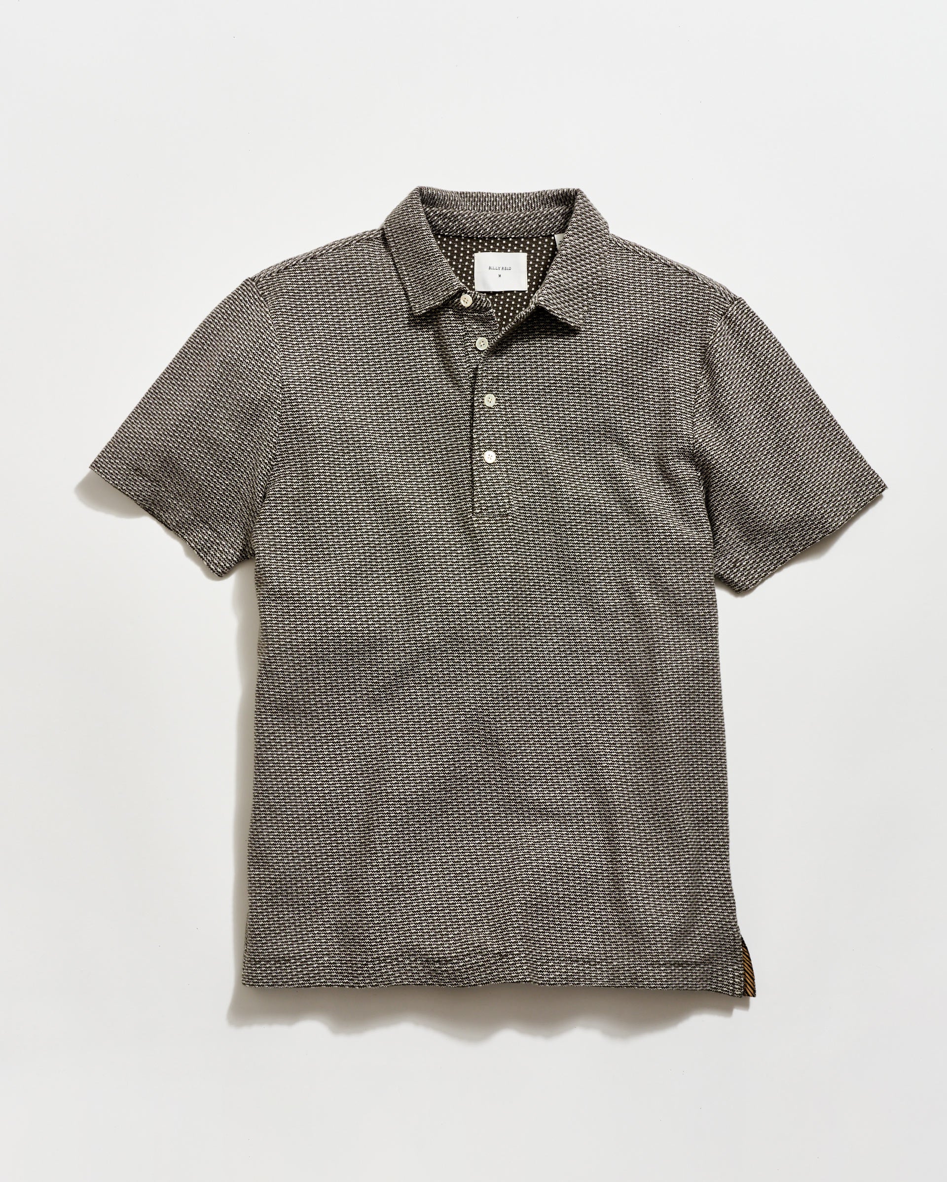 Gray patterned polo shirt on a light gray background