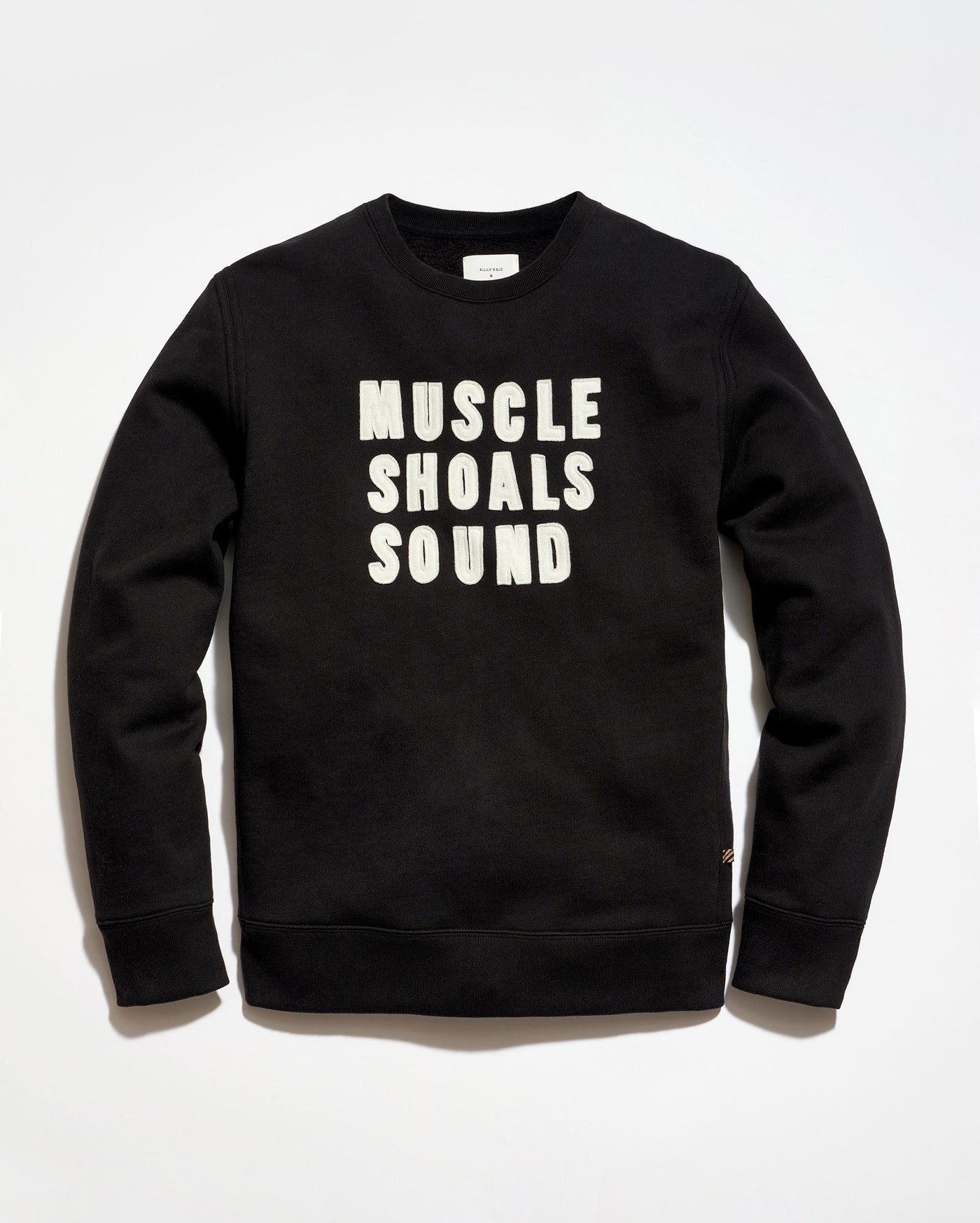 Black sweatshirt with 'MUSCLE SHOALS SOUND' text on a white background