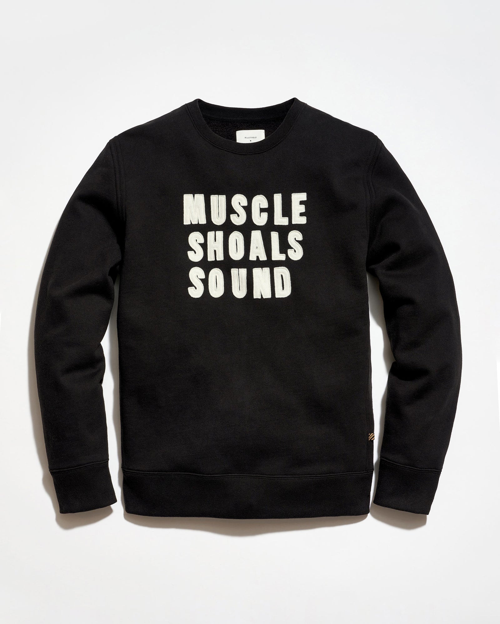 Black sweatshirt with 'MUSCLE SHOALS SOUND' text on a white background