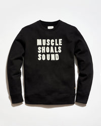 Black sweatshirt with 'MUSCLE SHOALS SOUND' text on a white background