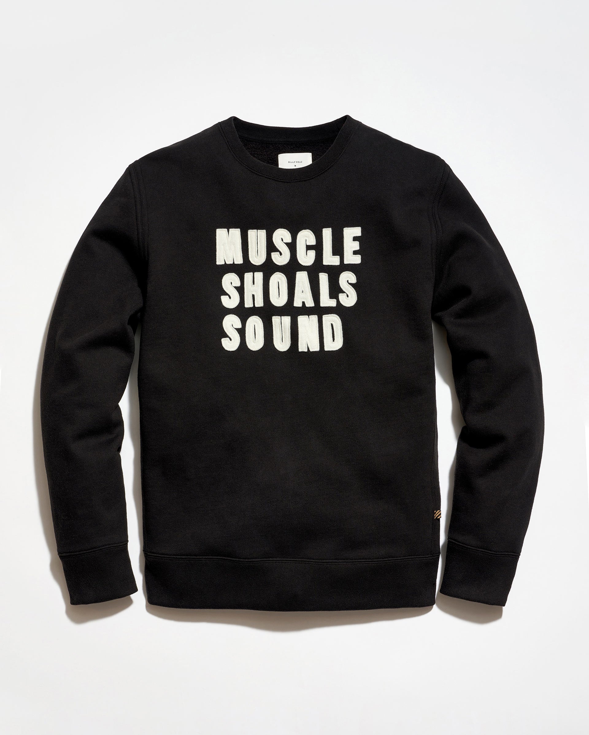 Black sweatshirt with 'MUSCLE SHOALS SOUND' text on a white background