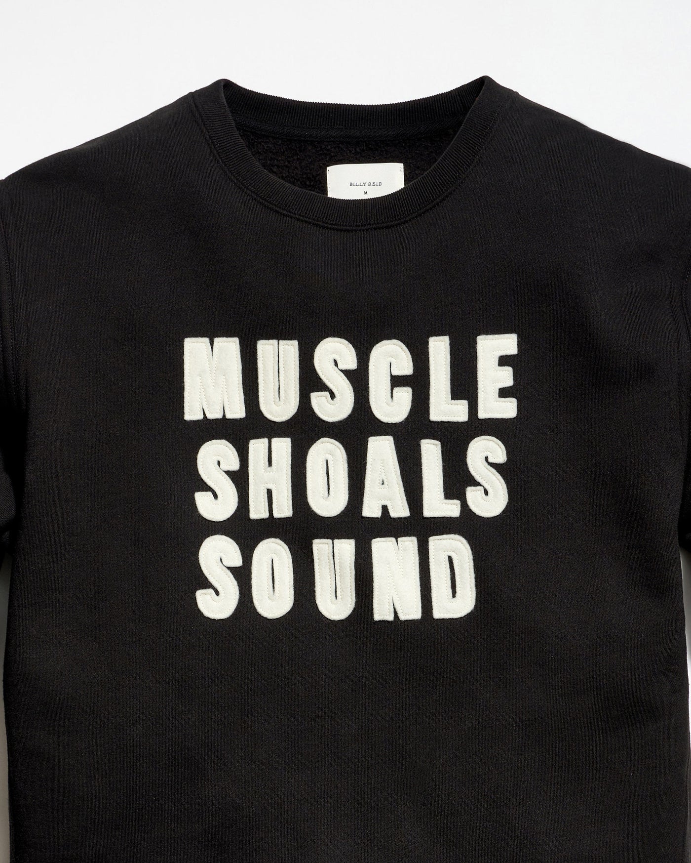 Black t-shirt with 'MUSCLE SHOALS SOUND' text on a white background